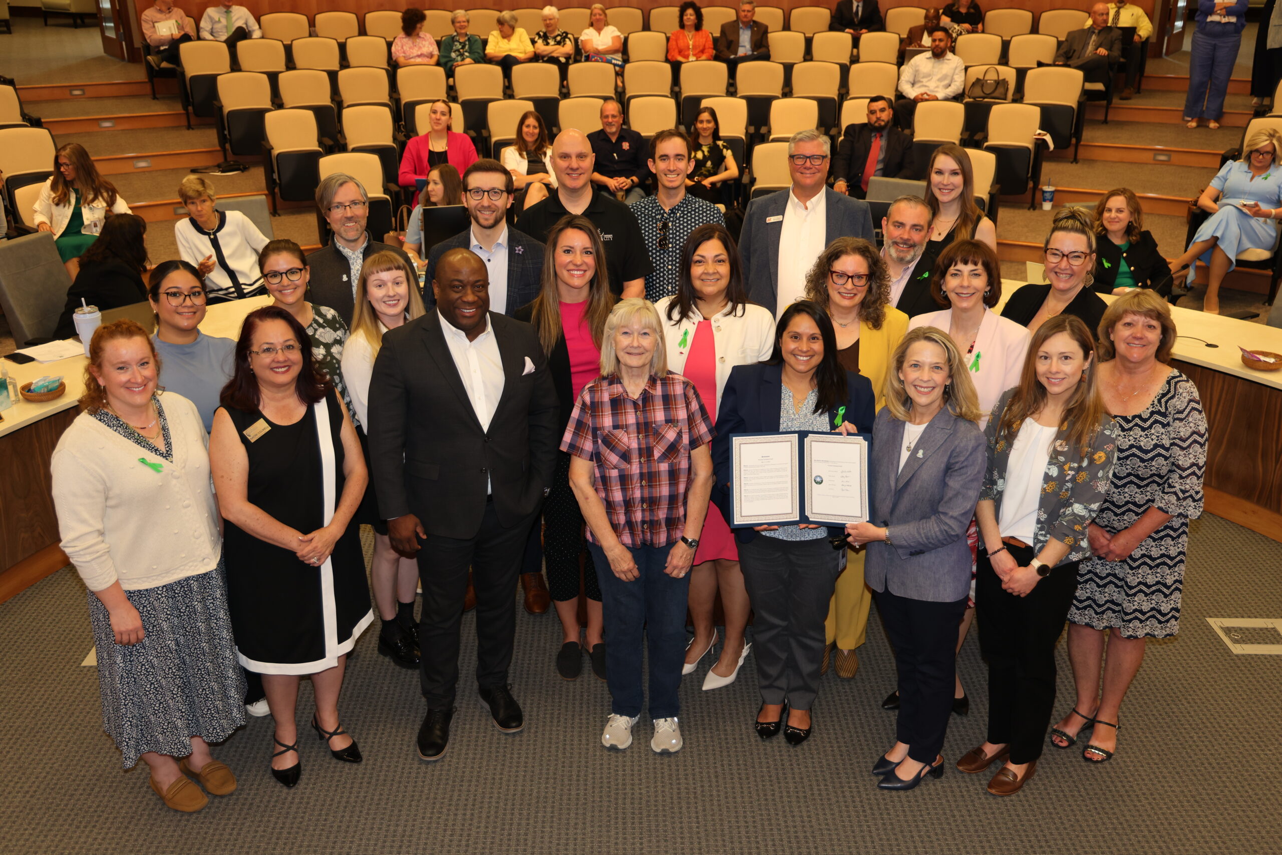 Group of professionals posing in an auditorium during National Economic Development Week.